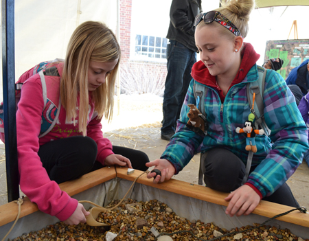 Two students dig for fossils.