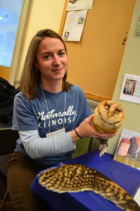 Exhibitor holds owl in the "Creatures That Are Not Afraid of the Dark" exhibit