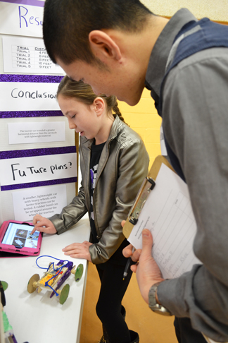 Next Gen student explains her project to Illinois engineer Keng Hsu.