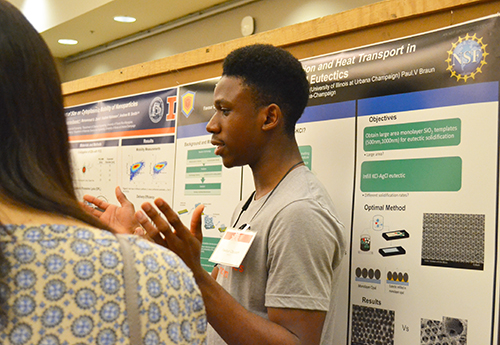 POETS REU participant Favour Obuseh discusses his research on Heat Transport with visitors.