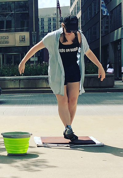 Image of Carmen Paquette street performing with her Broads on Boards dance  company. (Image courtesy of Carmen Paquette.