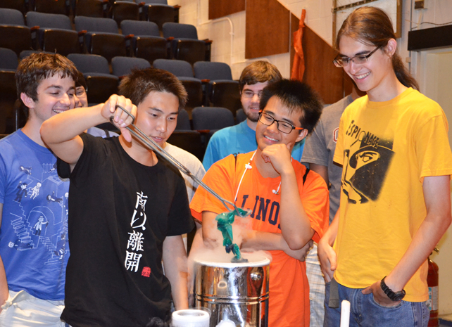 Physics Van trainees successfully perform the demo in which a baloon is placed in liquid nitrogen, causing the air in the balloon to contract and the balloon to shrivel.