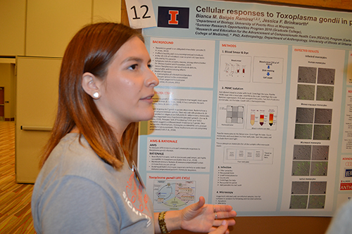 Bianca Baiges explains  her study on Toxoplasma gondii to a visitor to ISRS.