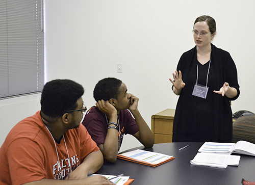 Left to right: David Alexander and Solomon McBride listen as Carrie Kouadio explains the EBICS REU components during the REU Orientation at the beginning of the summer