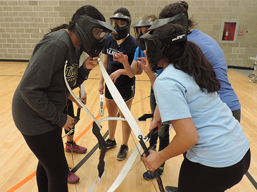 A team discusses strategy during a game at SWE's Archery Tag tournament in 2017. (Image courtesy of Nika Steffen.)