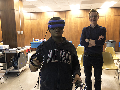 Andre Schleife (right) enjoys exposing a student to virtual reality during a visit to MRL. (Image courtesy of Andre Schleife.) 
