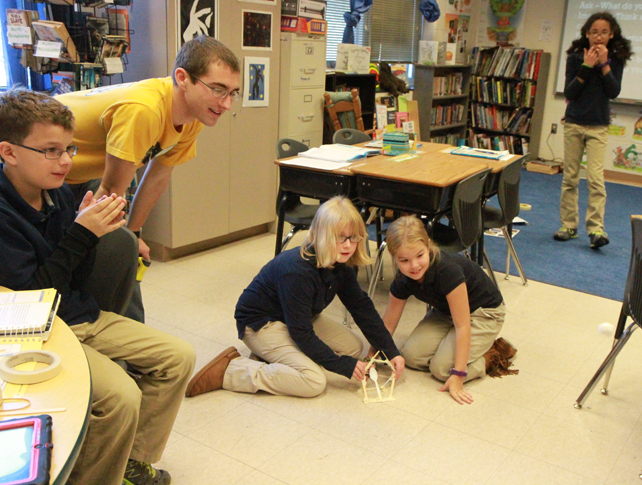 Nathan Dostart and several Stratton fourth-graders test the the effectiveness of the launcher they buillt by launching a cotton ball