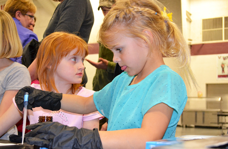 A Unity East student concentrates as she makes a mirror during a hands-on activity.