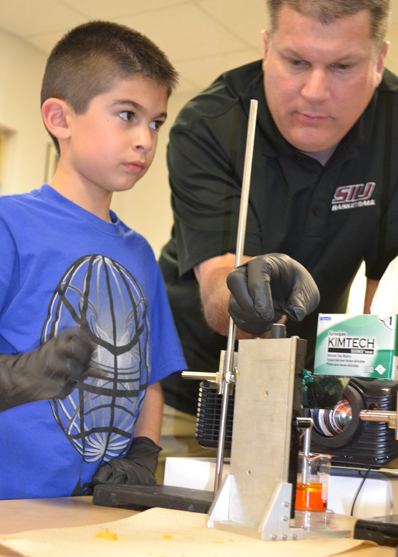 A Unity East student and his father do a 3D printing activity.