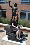 Amy Doroff sitting in front of the Quintessential Engineer statue.