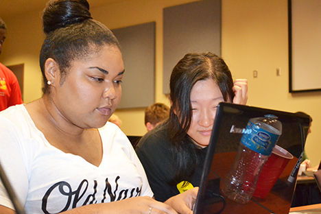 Robinson and a fellow intern work on parallel coding during a workshop session.