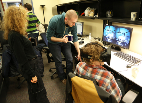 Donna and Couler supervise a student using Oculus.