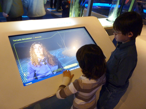 The children of AVL staff member Jeff Carpenter, Iain and Trinity, experience AVL's kiosk explaining the science of tornadoes at the Museum of Science and Industry.