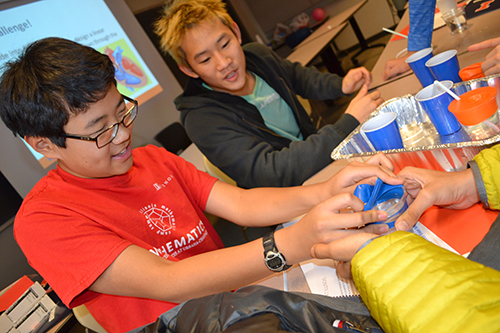 A group of 'Bioengineer Your Impact' participants work together to design a linear module that shows how blood flows through the different chambers of the heart.