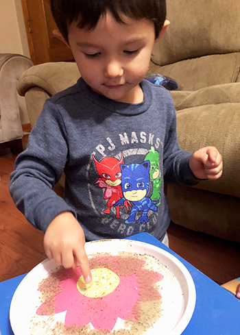 A local three-year-old participates in the surface tension hands-on acivity during the November 2nd CyC.