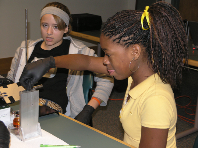 Edison Middle School student lowering the stage during a workshop NanoCEMMS' Matthew presented on rapid prototyping (3D printing).