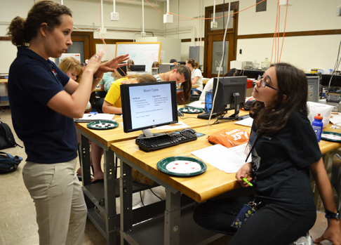 Kaitlin Tyler instructs one of the GLAM campers during the chocolate lab.