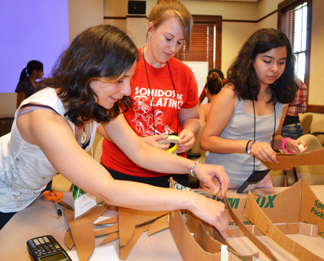 Elif Ertekin (left) lends a hand to a couple of campers during the solar oven session.