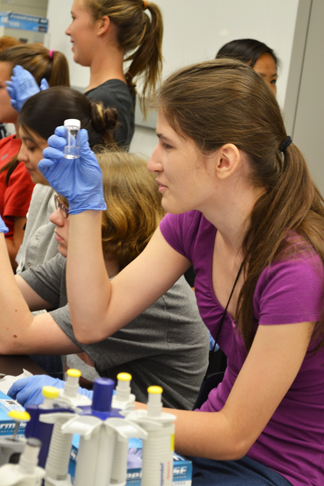 Camper examines some biomaterials during a session on stem cells.