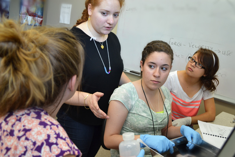 G.A.M.E.S. Bioengineering camp instructor Olivia Cangellaris works with the campers during a hands-on activity with frogs.