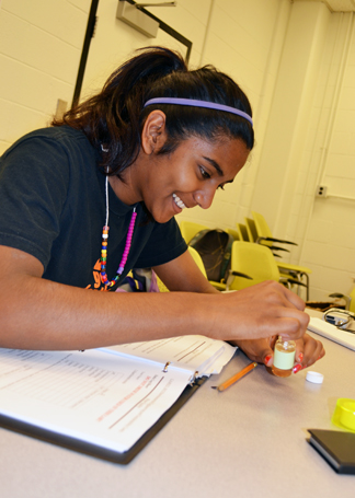 Camper using ph strip to test water sample.