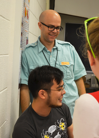 Timothy Strathmann (upper left), co-Director of the camp and a  graduate student instructor enjoy the water quality session.