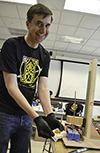 Joe Muskin shows off a 3D printed object one of the GAMES campers made on the 3D printer they designed and buil