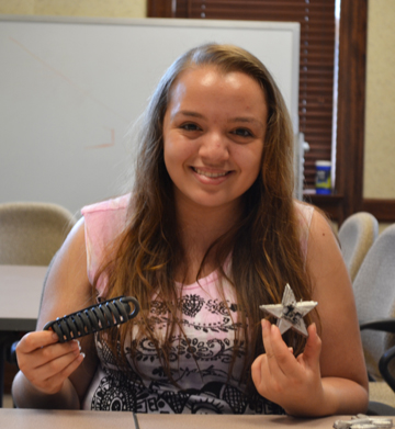 G-BAM camper Stephanie Smithson displays the items she made during some of the hands-on activities.