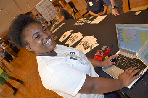 Tiari Hunter, a Centennial High School sophomore, checks over the project's code