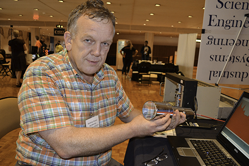 Professor Matthias Grosse Perdekamp (left) at the Pygmalion Festival, sets up his team's booth.