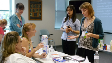 Sharlene Denos discusses lesson plan with teachers during iRISE professional development.