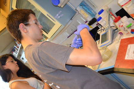 High school students Noah work on water filter.