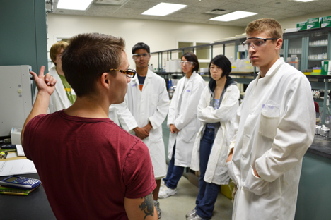 Chieli Moldonado (right) and some of the other campers listen as grad student Derek Varden explains about biofuels.