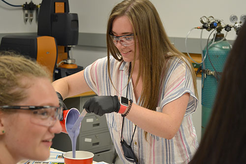 A GLAM camper does a mold-making activity. (Image courtesy of I-STEM undergrad Sooah Park.)